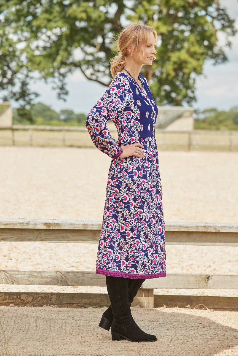 Lily Ella collection elegant navy blue floral mid-length dress with long sleeves styled with black heeled boots for a chic outdoor look