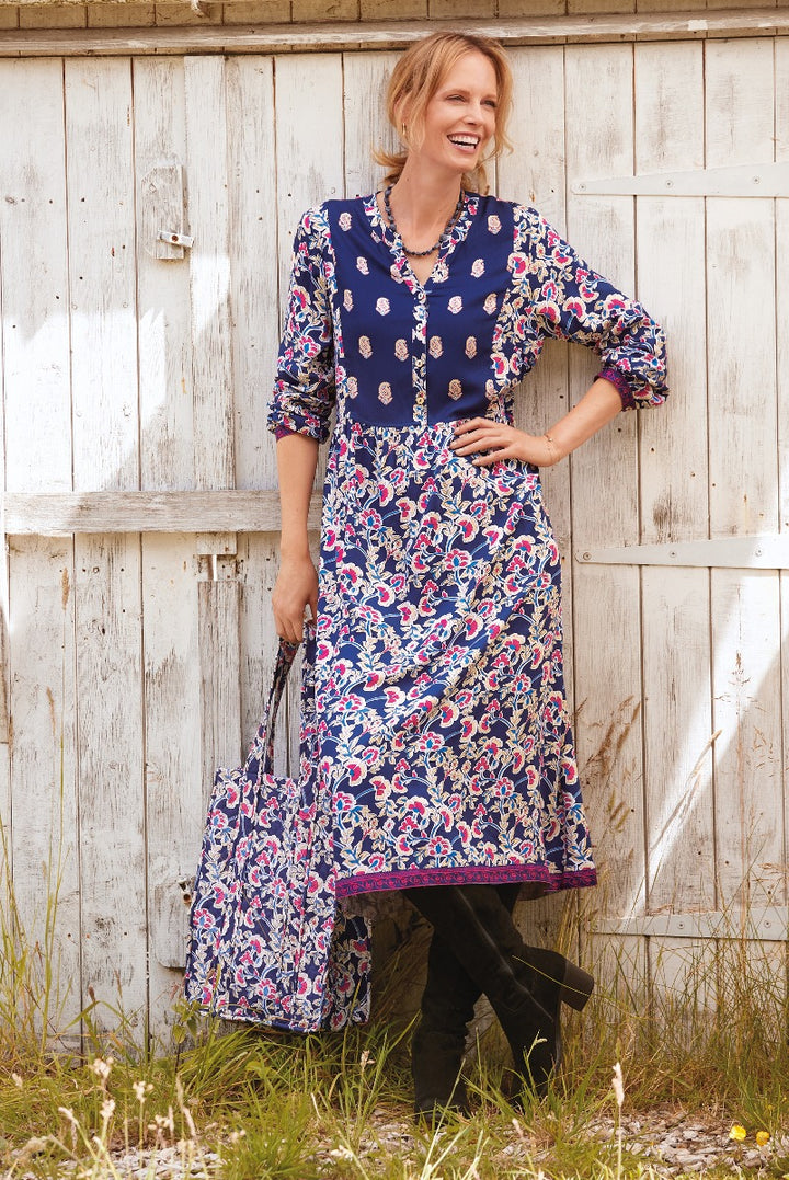 Lily Ella Collection navy blue floral patterned dress with three-quarter sleeves, styled with boots, outdoor rustic wooden background