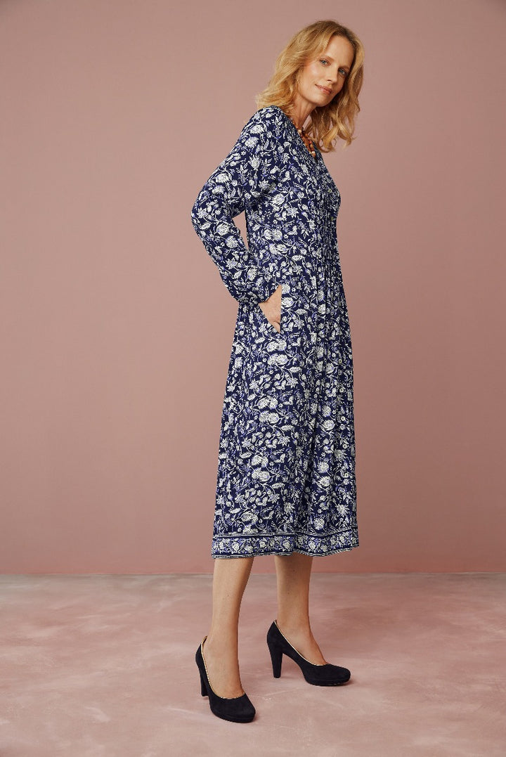 Lily Ella Collection elegant floral pattern navy midi dress with long sleeves, side pockets and black heels on a model, perfect for casual or formal wear