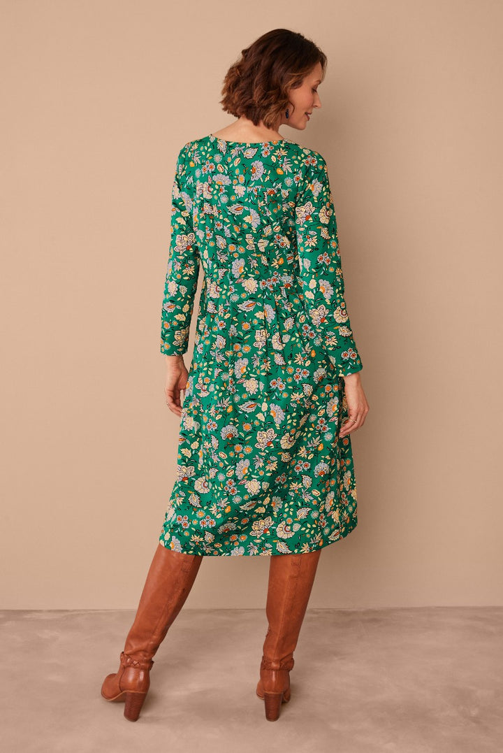 Lily Ella Collection green floral midi dress paired with tan leather boots, featuring elegant long sleeves and a comfortable fit for stylish women's fashion.