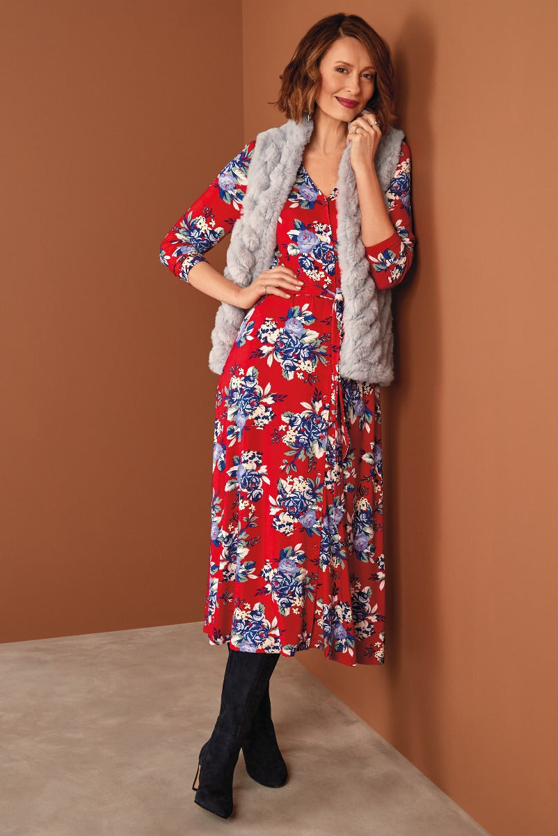 Lily Ella Collection red floral midi dress with blue and white print paired with a grey faux fur cardigan and black suede boots for a chic autumn outfit