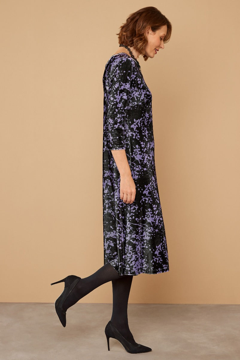 Lily Ella Collection elegant purple floral velvet dress, 3/4 sleeves, mid-length, fashion-forward women's apparel, styled with black tights and heels