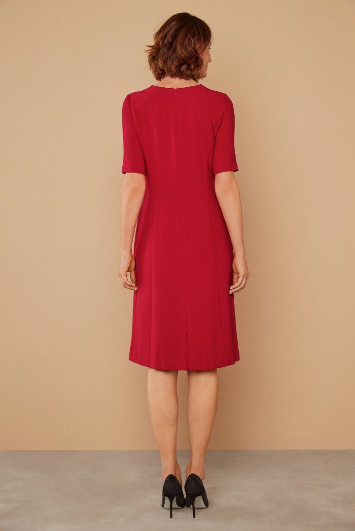 Lily Ella Collection elegant red A-line dress with short sleeves and black heels rear view