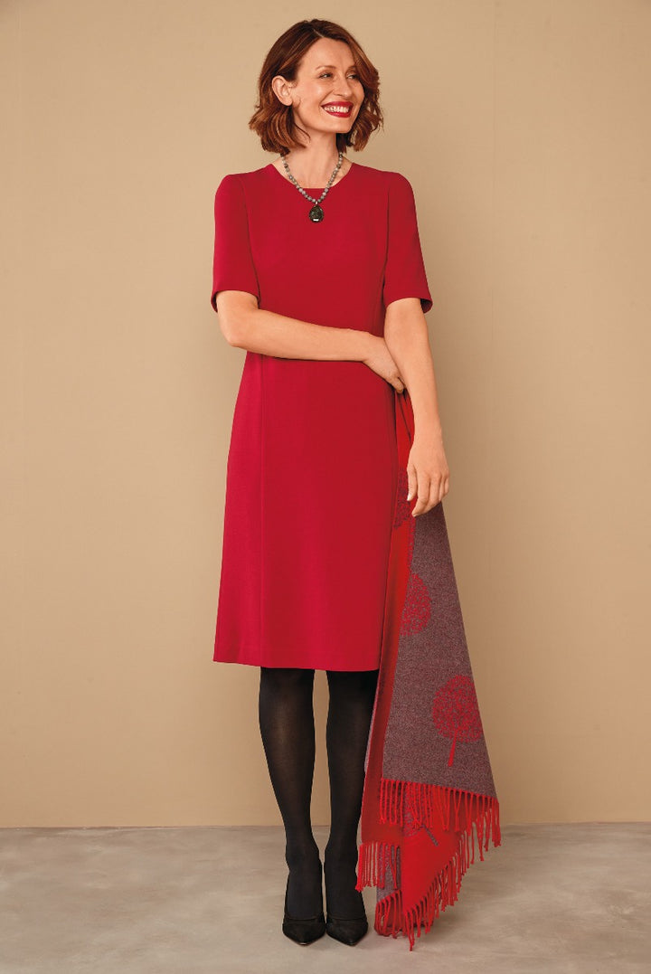 Lily Ella Collection elegant red A-line dress with short sleeves, paired with black tights and heels, accessorized with statement necklace, complemented by a red and grey floral fringed scarf.