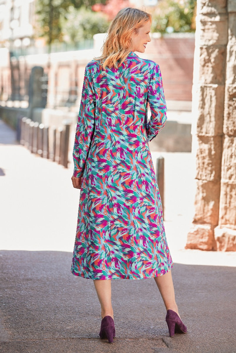 Lily Ella Collection vibrant pink, blue, and teal feather print midi dress with stylish ankle boots, showcasing women's autumn fashion and elegant casual wear.