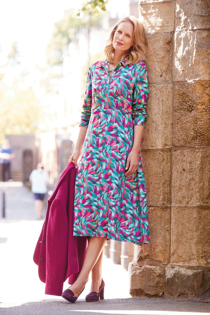 Lily Ella Collection vibrant pink and turquoise printed shirt dress paired with maroon coat and matching heels for a chic, stylish look.