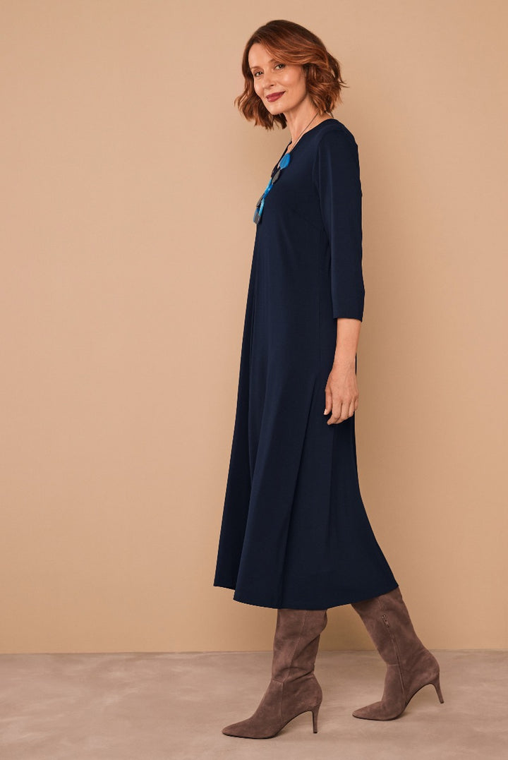 Lily Ella Collection elegant navy blue midi dress, mature woman modeling with taupe high-heeled boots, stylish three-quarter sleeves, sophisticated casual wear