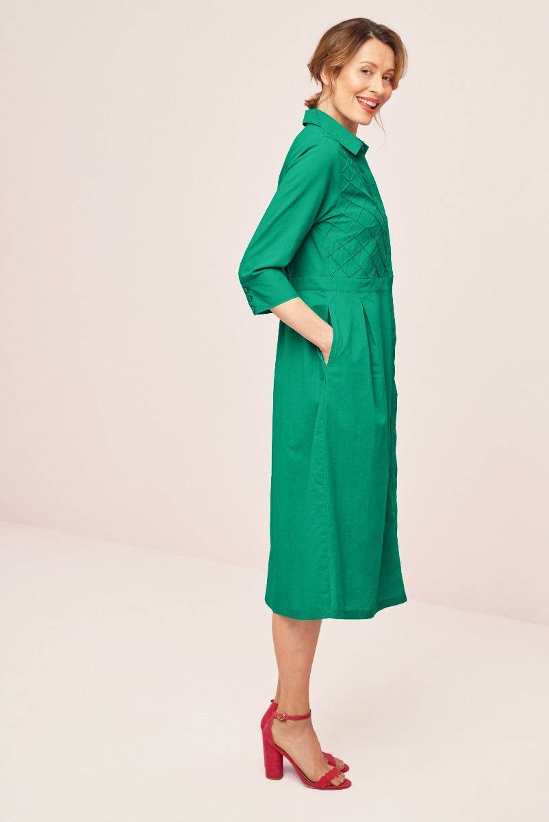 Lily Ella Collection emerald green quilted jacket dress midi length with stylish collar and red high-heeled sandals