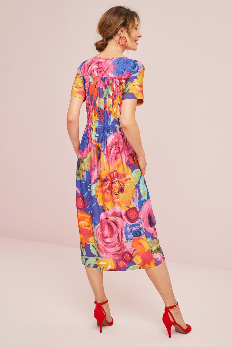 Lily Ella Collection vibrant blue floral midi dress with red high heels, stylish summer fashion, colorful floral print dress rear view