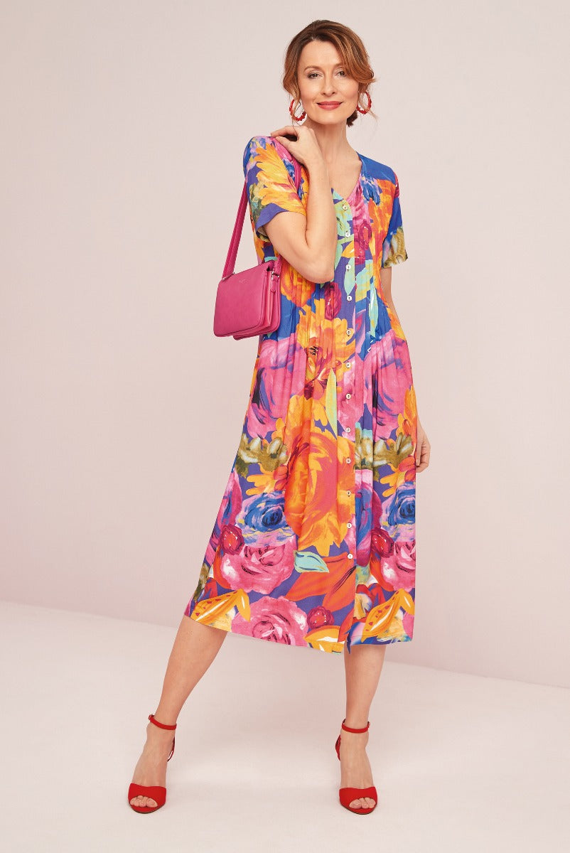 Lily Ella Collection vibrant floral-print midi dress in pink and blue with matching pink crossbody bag and red sandals for stylish women's summer fashion.
