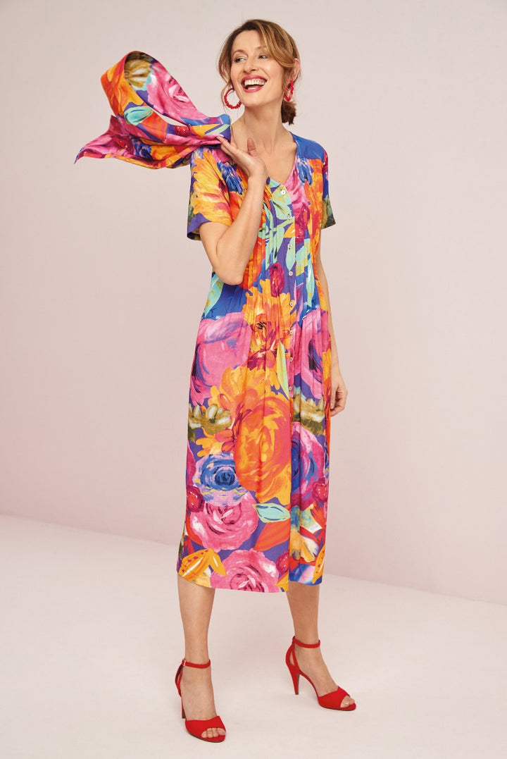 Lily Ella Collection vibrant multicolor floral print dress and red high heel sandals, stylish summer outfit, joyful woman with flowing scarf, fashion photography, bright and colorful clothing ensemble