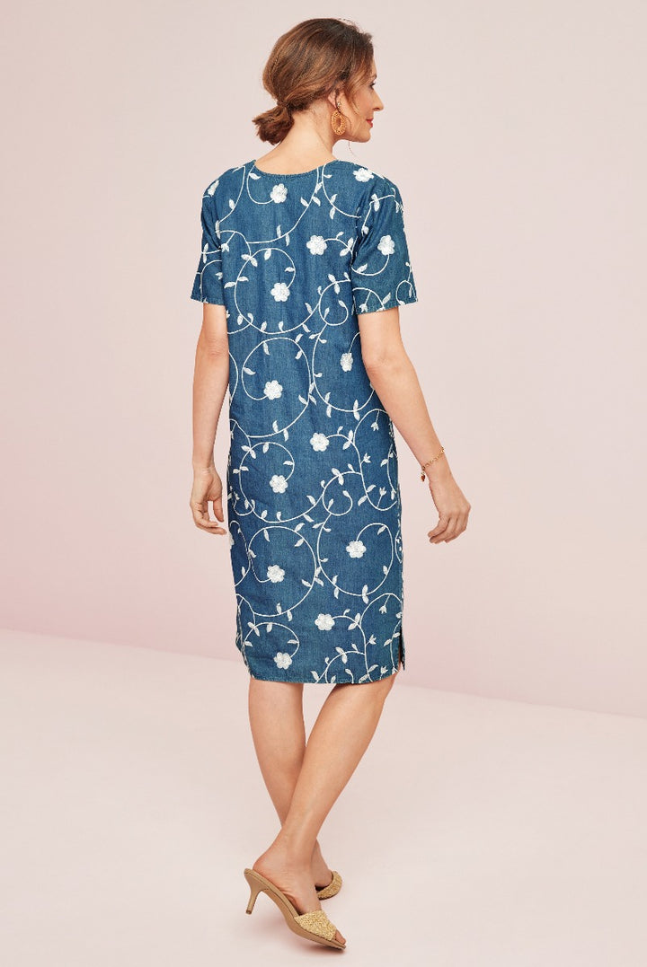 Lily Ella Collection denim-look floral pattern dress in blue, stylish mid-length with short sleeves, elegant women's fashion, paired with gold heels.