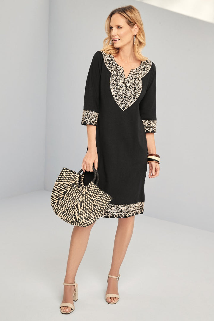 Lily Ella Collection elegant black dress with contrasting patterned trim, stylish three-quarter sleeves, and coordinating large straw bag, for sophisticated women's fashion.
