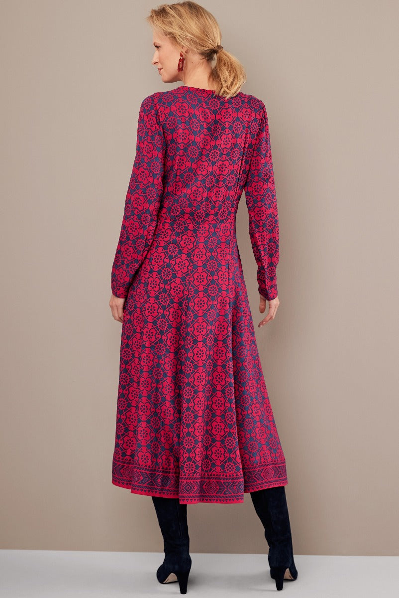 Lily Ella Collection elegant patterned magenta dress, long-sleeved midi design with boutique-style print, paired with navy blue boots, stylish autumn-winter women's fashion.