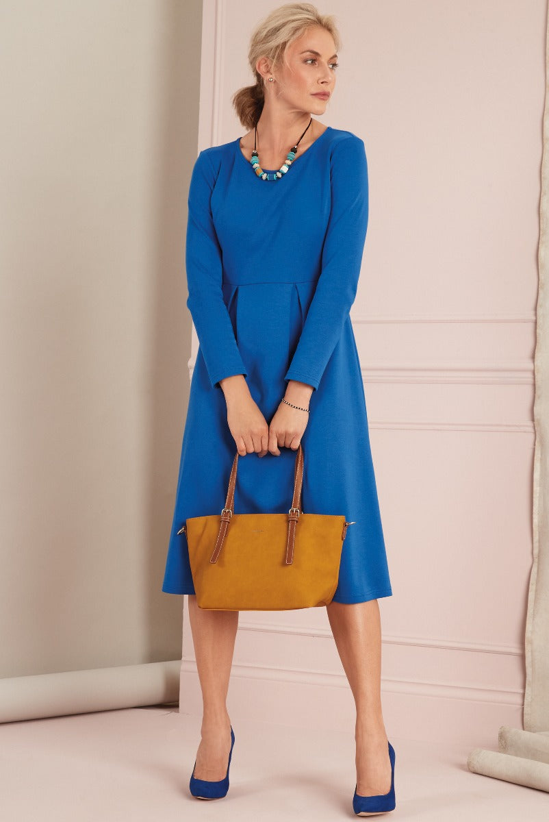 Lily Ella Collection elegant blue dress styled with coordinating accessories and yellow handbag, showcasing sophisticated women's fashion and timeless style.