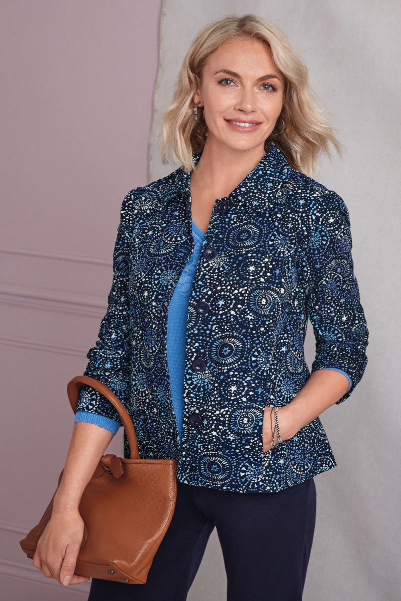 Lily Ella Collection navy blue and teal patterned jacket for women, stylish mandala-inspired print, casual elegant blazer with coordinating blue top and tan leather handbag, fashionable attire for sophisticated look.