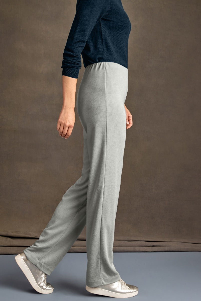 Lily Ella Collection light grey stylish comfort-fit trousers paired with navy blue top and metallic flats, fashionable women's clothing.