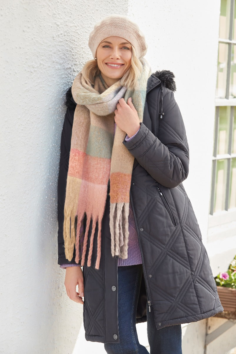 Lily Ella Collection stylish quilted charcoal grey winter coat paired with multi-colored pastel check scarf and beige knit beanie, fashion-forward women's outerwear for cold weather.