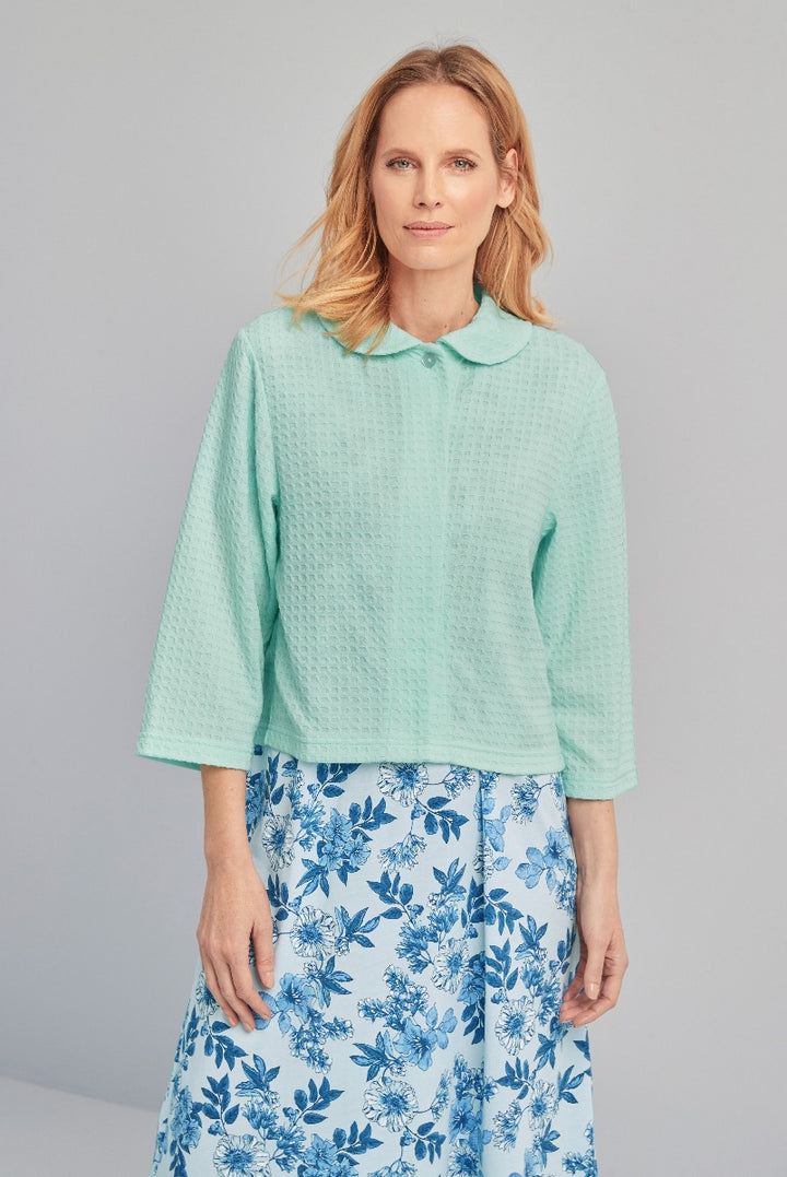 Lily Ella Collection mint green textured blouse with peter pan collar paired with blue floral print skirt, elegant women's spring fashion and style.
