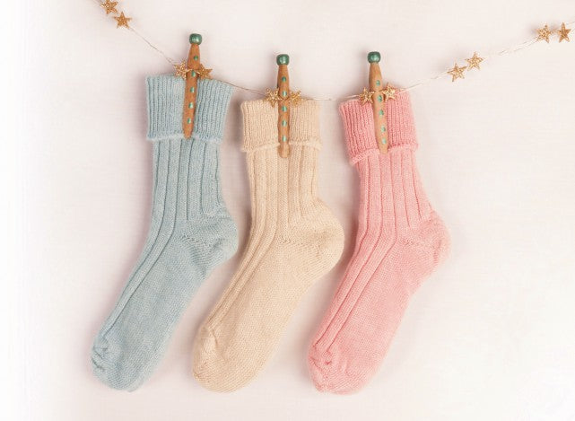 Lily Ella Collection pastel knit socks in blue, cream, and pink displayed with decorative star garland, cozy women's fashion accessories.