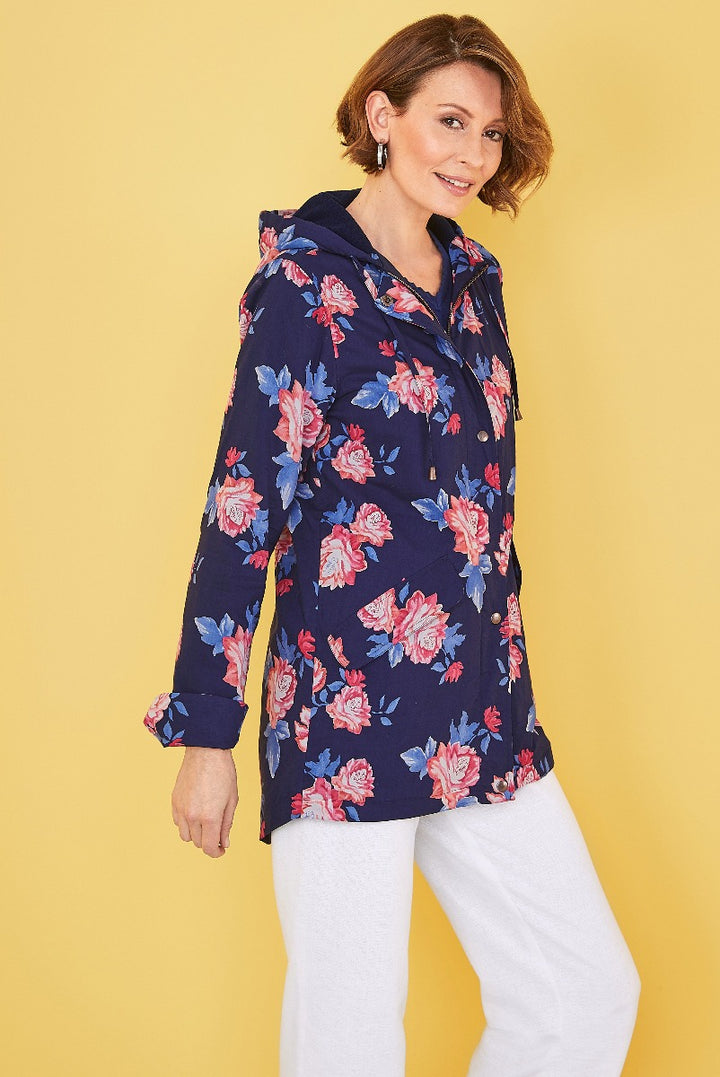 Lily Ella Collection navy floral patterned hoodie with pink and blue flowers, casual women's fashion, styled with white trousers against yellow background