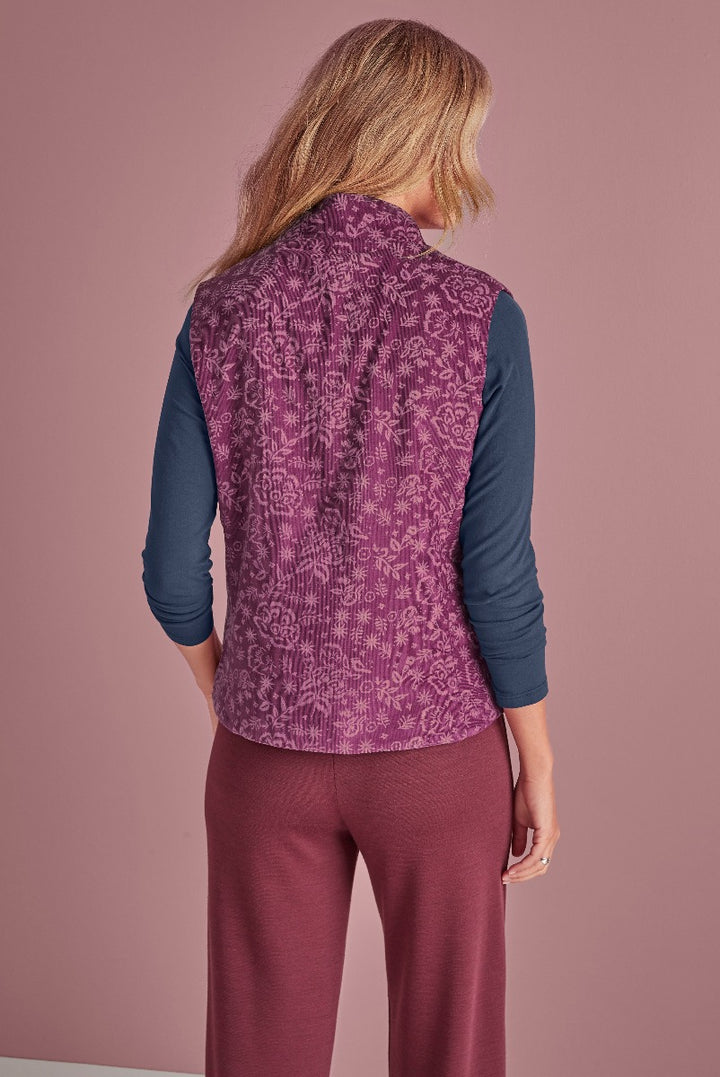 Lily Ella Collection purple patterned quilted gilet with navy blue long sleeve top and coordinating trousers, women's stylish layered autumn outfit, fashion clothing rear view