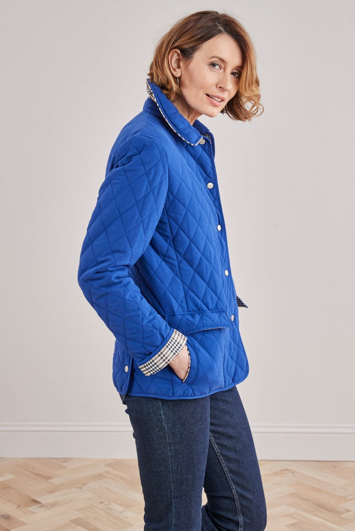 Lily Ella Collection blue quilted jacket for women, featuring a classic collar with checkered pattern detail, button-up front, and side pockets.