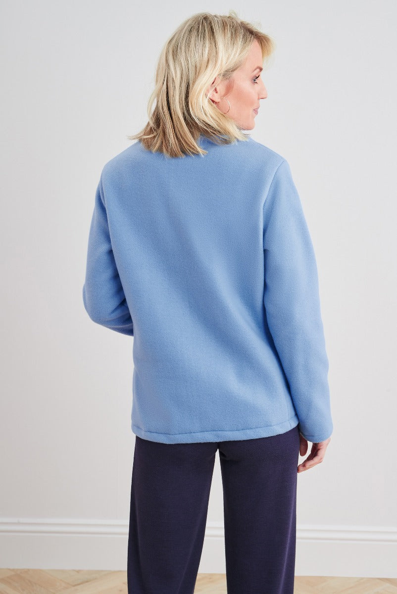 Lily Ella Collection light blue casual crewneck sweater for women, comfortable fit with ribbed cuffs, styled with navy trousers, elegant everyday wear.