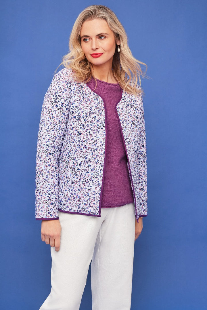 Lily Ella Collection floral print jacket in purple and white, styled with a coordinating purple sweater and white trousers, elegant women's spring fashion.