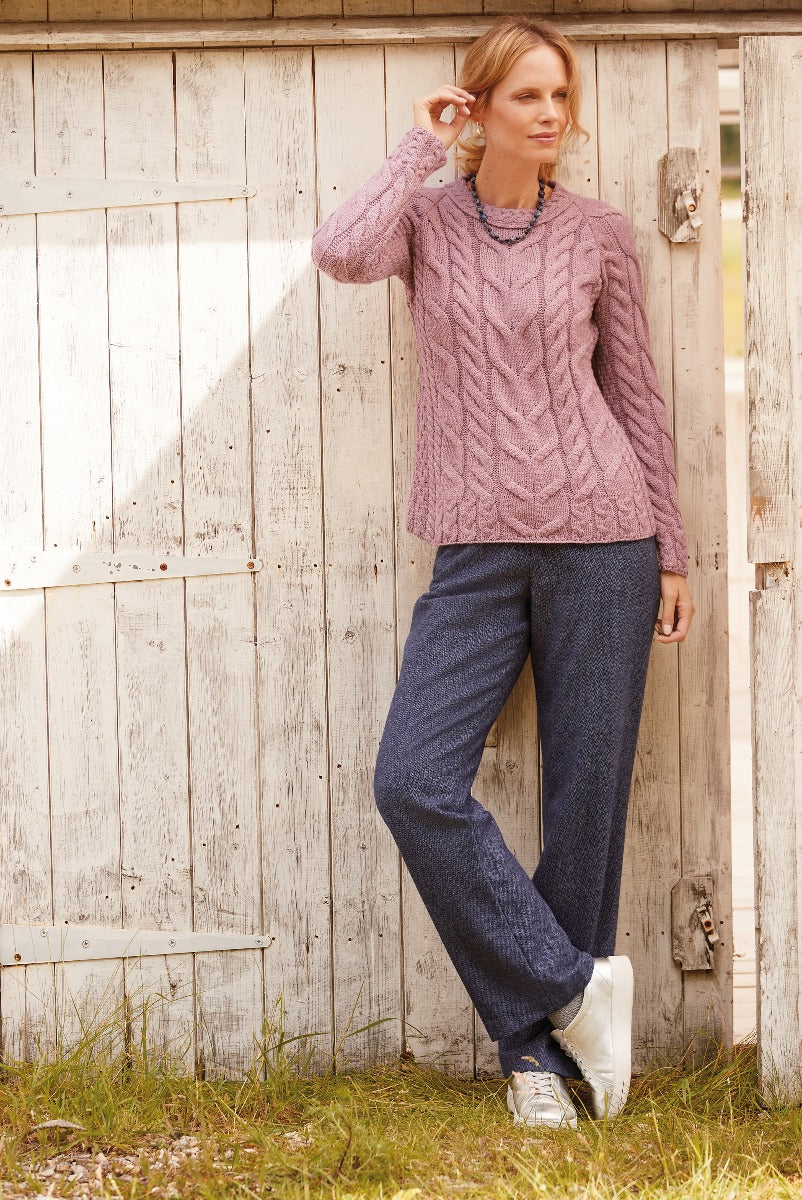 Lily Ella Collection women's fashion, model wearing Mauve Cable Knit Jumper and Navy Textured Trousers, casual elegant style, outdoor setting with wooden background