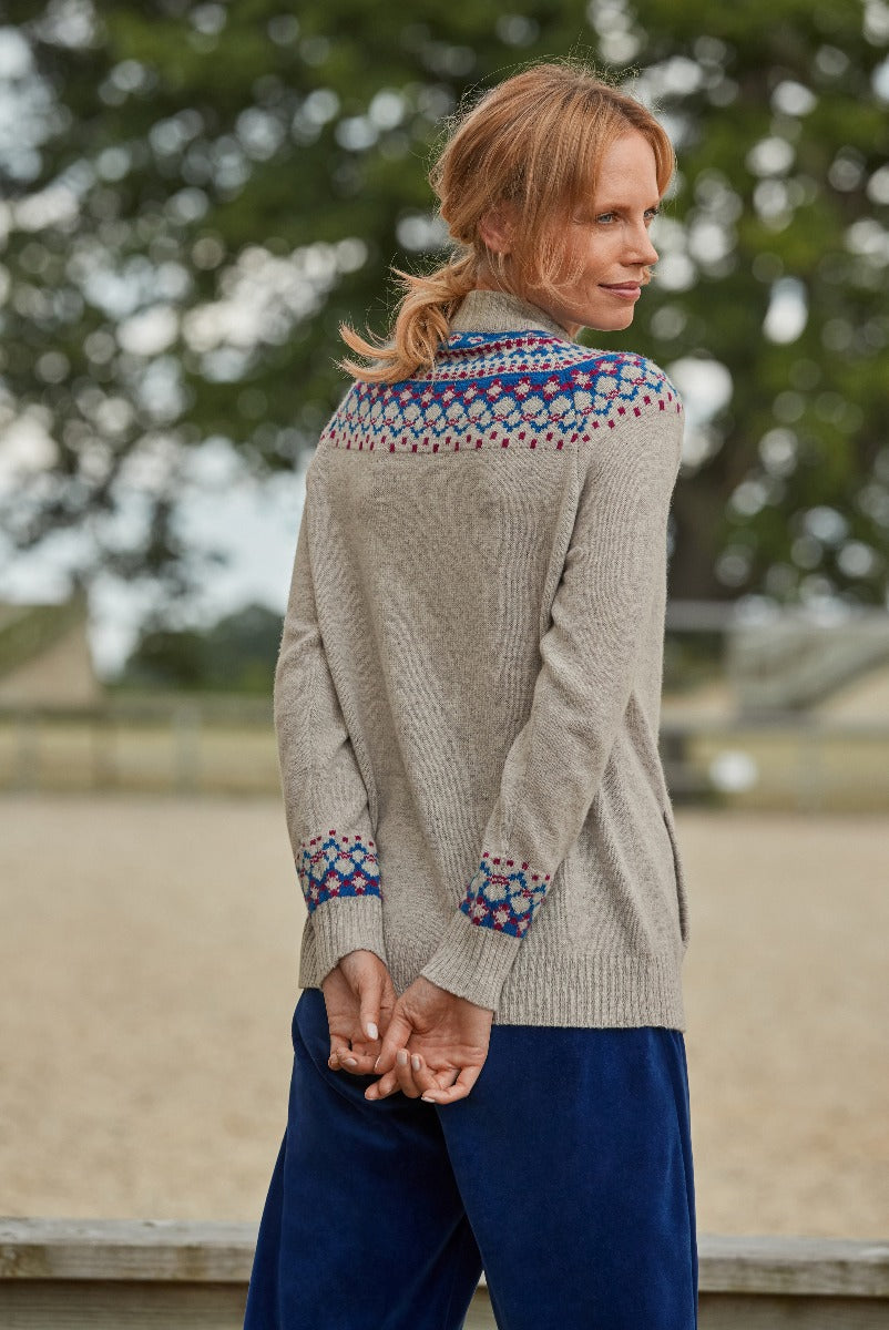 Lily Ella Collection women's oatmeal lambswool cardigan with intricate blue and red fair isle pattern, casual chic style, paired with navy trousers, outdoor autumn fashion.