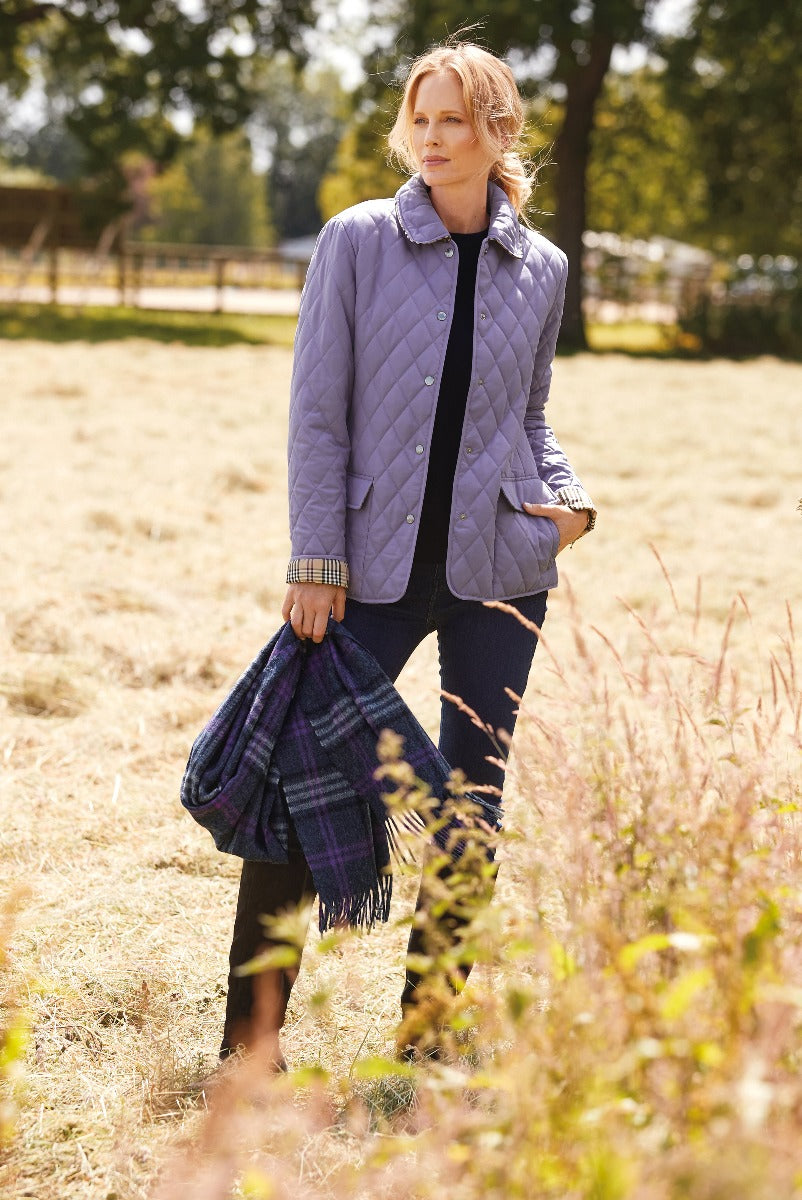 Lily Ella Collection stylish lavender quilted jacket for women autumn fashion paired with navy trousers and plaid scarf outdoors