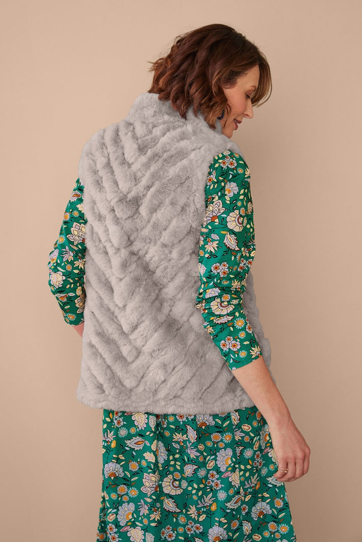 Lily Ella Collection elegant gray faux fur gilet paired with floral green dress, stylish women's outerwear and fashion-forward clothing ensemble.
