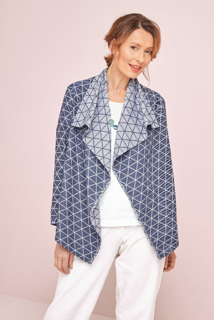 Lily Ella Collection stylish navy geometric pattern jacket on model paired with white pants and casual top for sophisticated women's fashion.