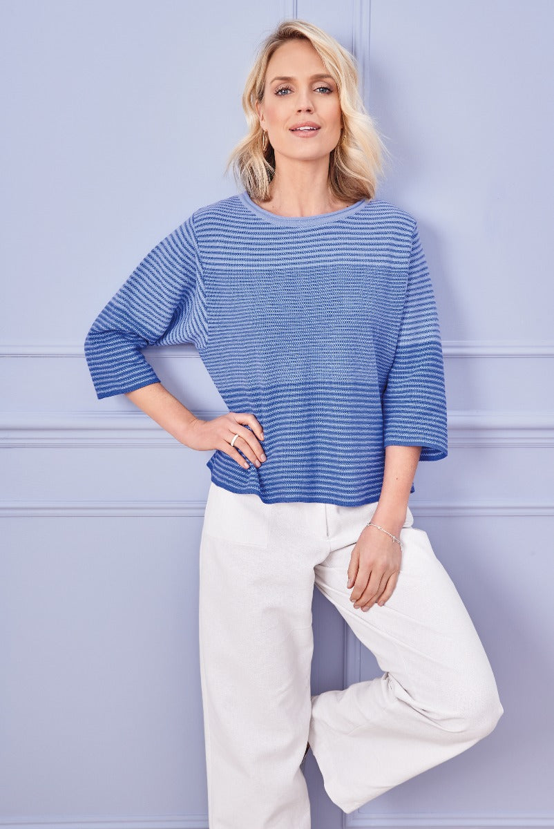 Lily Ella Collection blue and white striped pullover with contemporary three-quarter sleeves paired with chic white trousers, stylish casual women's outfit.