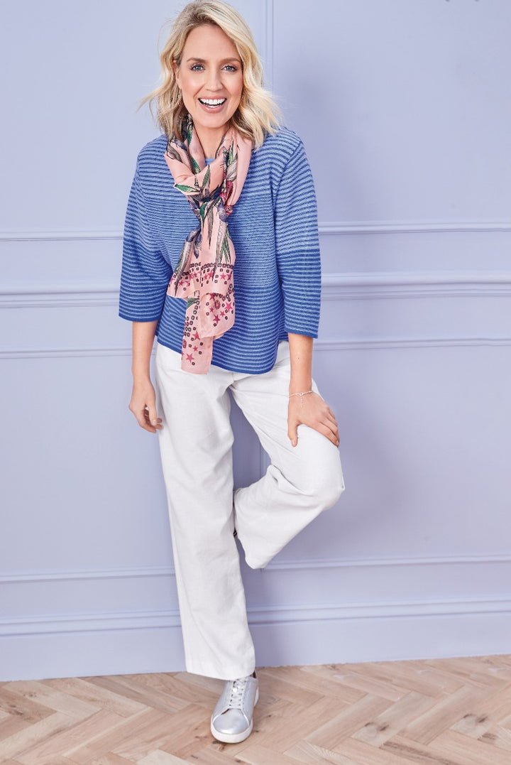 Lily Ella Collection stylish blue knitwear, white linen trousers, and floral scarf, comfortable casual chic women's fashion.