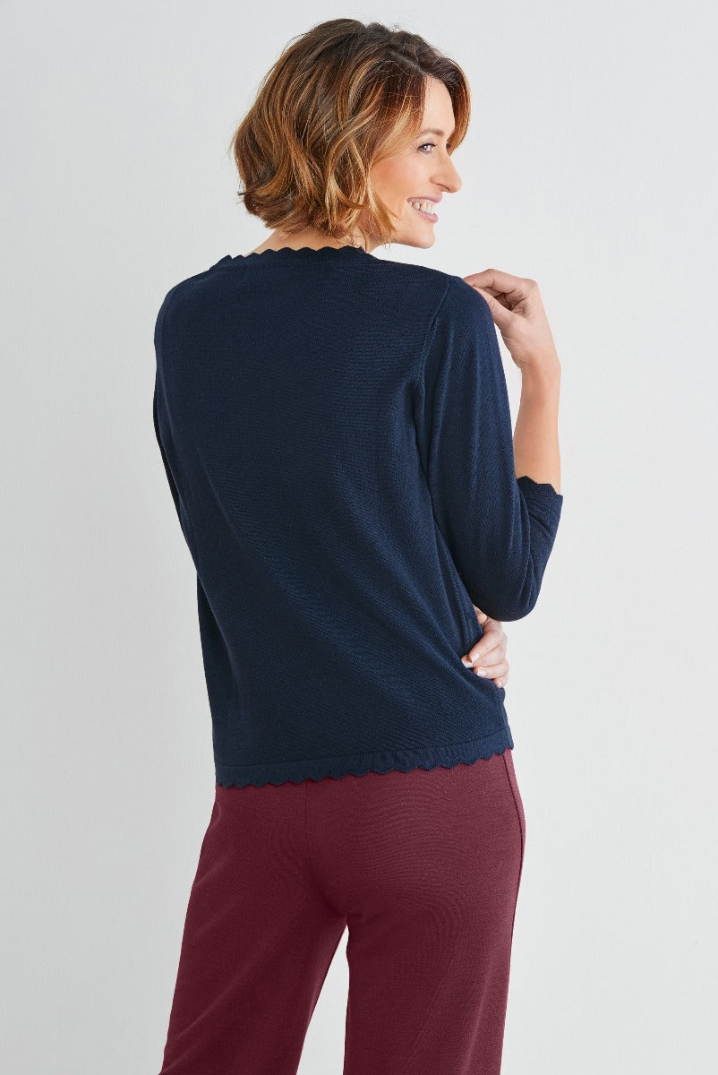 Lily Ella Collection navy blue knitted sweater with scalloped hem detail paired with maroon trousers, elegant casual women's fashion, comfortable chic clothing.