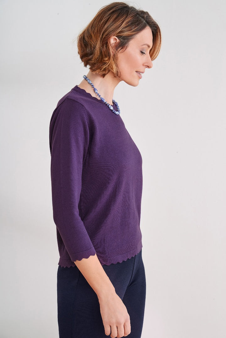 Lily Ella Collection purple scalloped-edge knit jumper with model showcasing elegant style, paired with statement necklace, ideal for sophisticated casual wear.