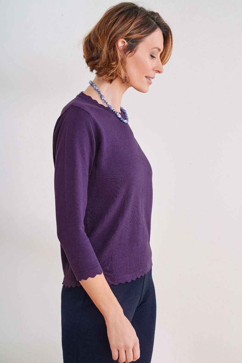 Lily Ella Collection elegant purple scalloped hem jumper, women's stylish knitwear, paired with navy trousers and blue statement necklace.