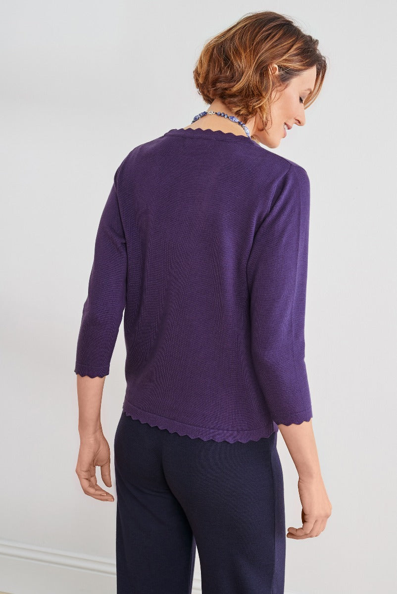 Lily Ella Collection elegant indigo scallop-trimmed cardigan, casual three-quarter sleeve knitwear, woman modeling stylish back view, fashion outfit inspiration.