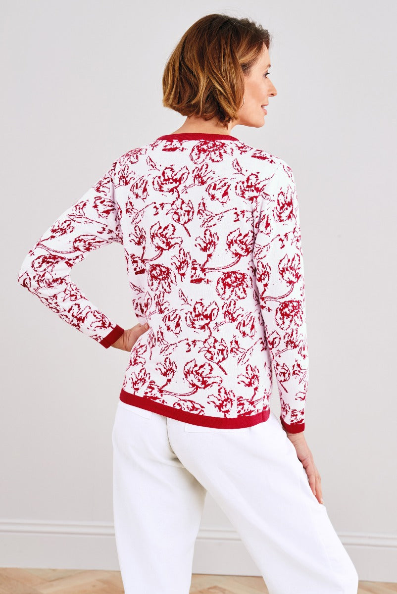 Lily Ella Collection red floral printed sweater with ribbed trim and white trousers for women, stylish casual wear.