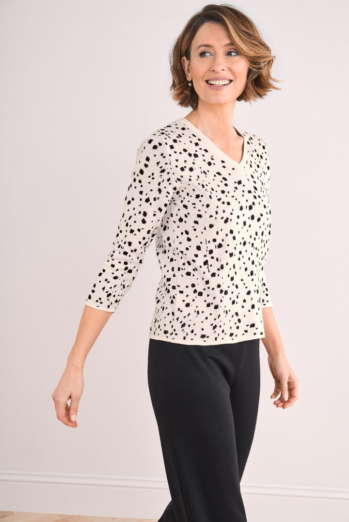 Lily Ella Collection cream and black polka dot knit top, stylish women's 3/4 sleeve V-neck jumper, casual chic clothing, model posing in elegant patterned sweater