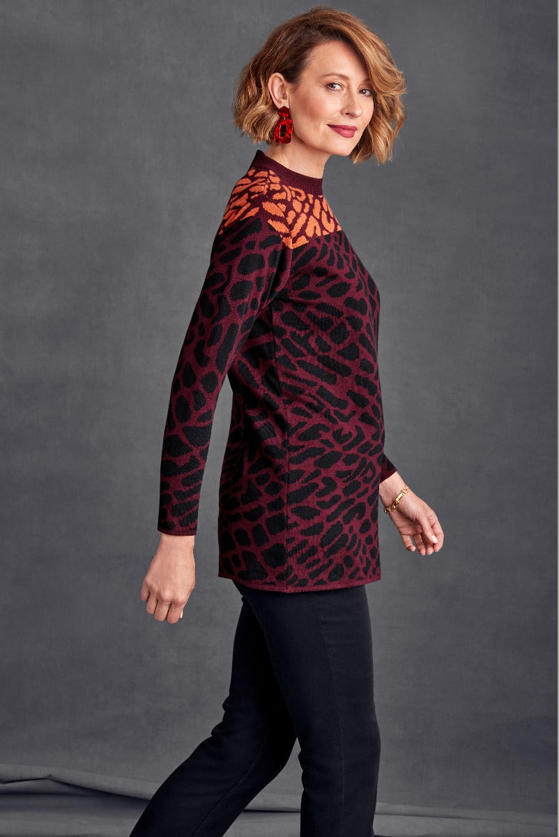 Lily Ella Collection elegant maroon and black animal print tunic top, stylish long sleeves, comfortable fit, woman modeling fashionable casual wear suitable for autumn/winter season.