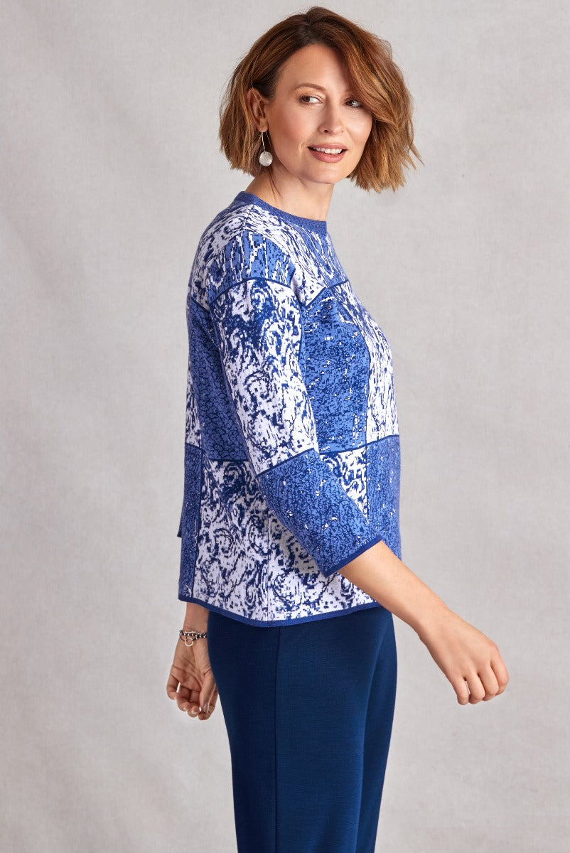 Lily Ella Collection stylish blue and white patterned knit top with sequin detailing paired with elegant navy trousers for mature women's fashion.