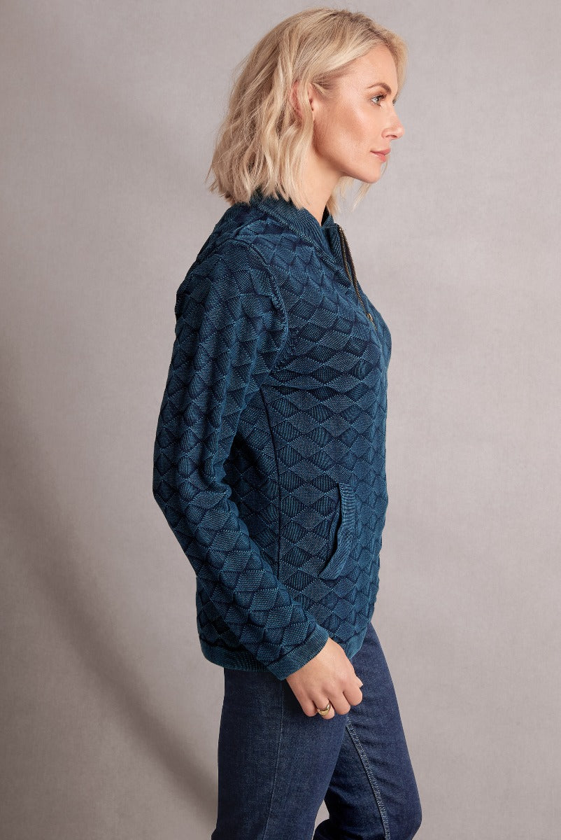 Lily Ella Collection navy blue quilted jacket, women's textured outerwear, side profile view, stylish casual fashion, paired with jeans.