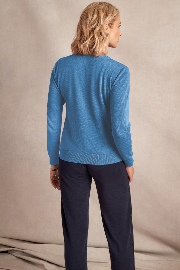 Lily Ella Collection blue knit sweater, women's casual long-sleeve top, comfortable ribbed texture jumper, paired with navy trousers, fashion model showcasing back view, stylish autumn-winter apparel