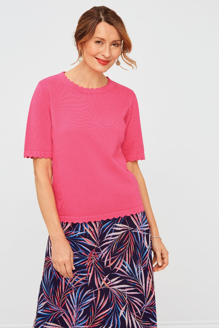 Lily Ella Collection pink scalloped-edge short-sleeve blouse paired with tropical print skirt, stylish women's spring-summer fashion clothing.