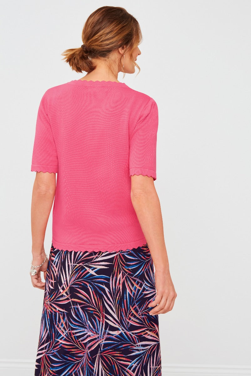 Lily Ella Collection pink scallop-trimmed top paired with a vibrant tropical print skirt, showcasing stylish women's summer fashion and elegant casual wear