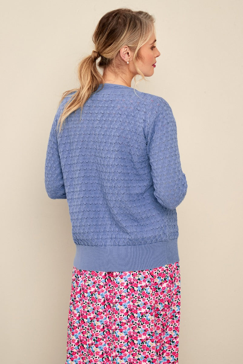 Lily Ella Collection periwinkle blue textured knit cardigan with ribbed trim paired with floral print skirt, elegant casual women's fashion.
