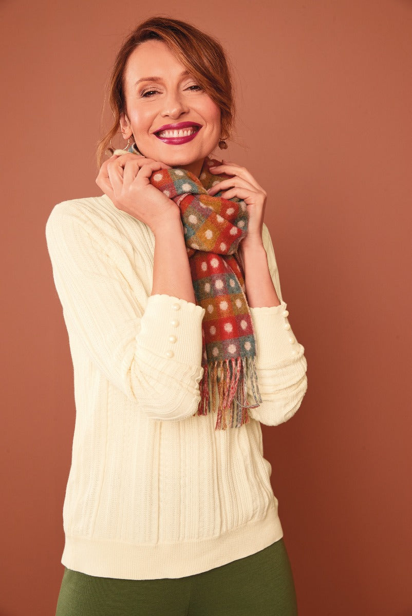 Lily Ella Collection cream cable knit sweater and colorful polka dot scarf with fringe, stylish woman posing in autumn fashion outfit